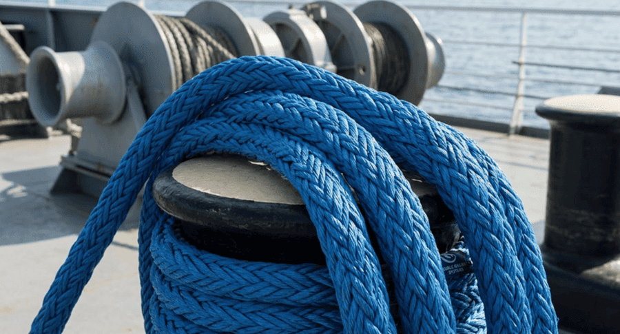 Duracordix - Your Trusted Supplier for High-Performance Synthetic Rope & Netting | HMPE vs. Nylon vs. Polyester vs. PP – How to Choose the Right Mooring Rope Material DURACORDIX blue 12-strand braided synthetic mooring rope on a vessel deck, showcasing high-tensile fiber texture and winch compatibility