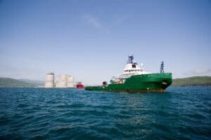 Green offshore vessel on open water using mooring lines to tow or position large floating structures